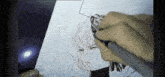 a person is drawing a picture with a pen