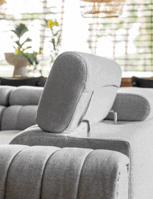 the back of a grey couch with a headrest