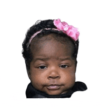 a baby girl with a pink bow in her hair
