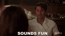 a man in a chef 's uniform is talking to a woman and the word sounds fun is on the screen