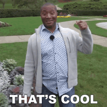 a man in a polka dot shirt says that 's cool while pointing