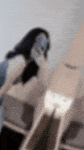 a blurry picture of a woman taking a selfie with a cell phone .