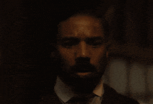 a man in a white shirt is holding a glowing object in his hands
