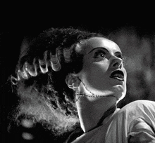 a black and white photo of a woman with a scar on her neck .