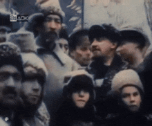 a group of people are gathered in front of a sign that says 24 ack