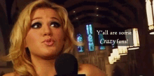 a woman speaking into a microphone with the words y all are some crazy fans