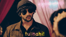 a man wearing sunglasses and a hat says tu nahi !