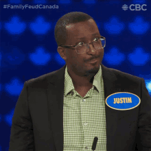 a man in a suit has a name tag that says justin on it
