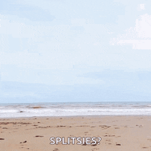 a woman is jumping in the air on a beach with the words splitsies written below her