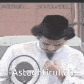 a man speaking into a microphone with the words " astaghfirullah " written below him