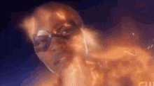 a man in a superhero costume is surrounded by flames and smoke .