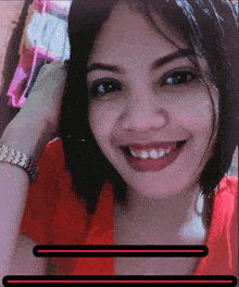 a woman in a red shirt is smiling with a black line in the middle of her face