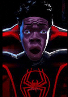 a close up of a man 's face in a spider-man suit with his mouth open .
