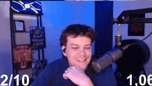 a man is smiling in front of a microphone with the numbers 1/10 and 1:06 next to him