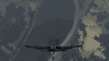 a plane is flying over a body of water and making a heart shape with its wings .