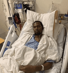 a man in a hospital bed with an oxygen mask on his nose