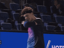 a man holding a tennis racquet with the number 4 on the handle