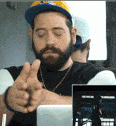 a man with a beard wearing a hat that says ' pittsburgh ' on it
