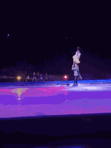a man is carrying a woman on his shoulders