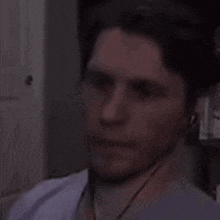 a man wearing headphones is making a funny face .