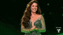 a woman in a dress is smiling on a stage .