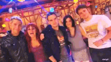 a group of people are posing for a picture together in a dark room .