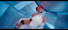 a woman with pink hair is wearing a white dress and white gloves in a video for vevo