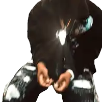 a person wearing a black hoodie and plaid pants holds their hands together