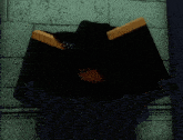 a black and yellow object is hanging on a brick wall .