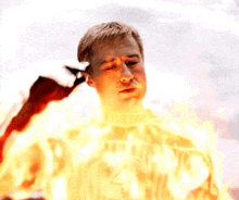 a man is surrounded by flames and has the number 4 on his shirt