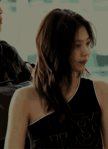 a woman is wearing a black tank top with the number 3 on it