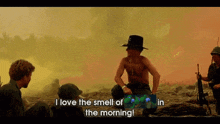 a man in a cowboy hat says " i love the smell of in the morning "