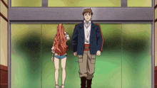 a man and a woman are standing next to each other in front of a glass door