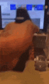 a blurry picture of a person sitting in front of a computer screen