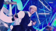 a man is dancing on a stage with a sign that says " break all the rules " on it