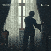 a hulu ad for nine perfect strangers shows a woman looking out a window