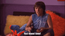 a man is sitting on a bed with a stuffed animal and says yes about time .