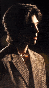 a man wearing a jacket with a fendi pattern