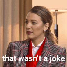 a woman wearing a plaid jacket and red scarf says that wasn 't a joke