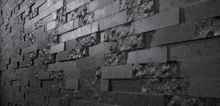 a black and white photo of a black brick wall