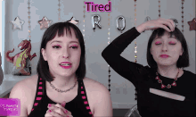 two women are standing next to each other with the word tired behind them