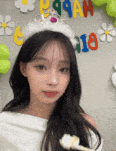 a girl with a crown on her head holds a toothbrush in front of a banner that says p99ah on it