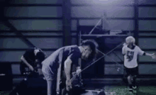 a group of men are playing a game of soccer in a dark room .