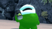 a green monster holds a can of rockstar energy drink