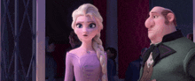 a woman in a purple dress and a man in a green suit are standing next to each other