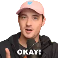 a man wearing a pink hat and a black jacket says okay