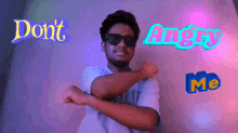 a man wearing sunglasses stands in front of a neon sign that says angry me
