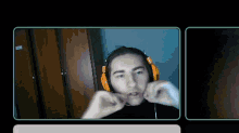 a man wearing headphones making a face with his hands