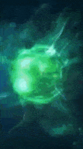 a green glowing object in a dark blue background
