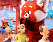a red panda mascot is standing in a crowd of people